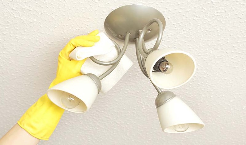 cropped picture of a person sprucing up light fixtures