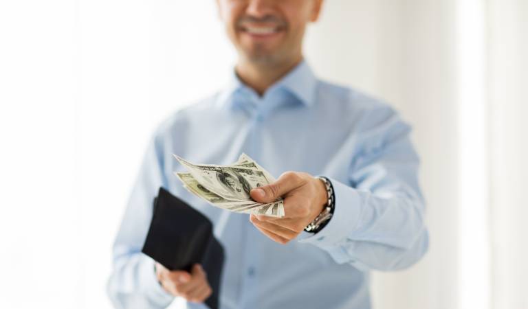 Man holding money in his hand and returning to someone