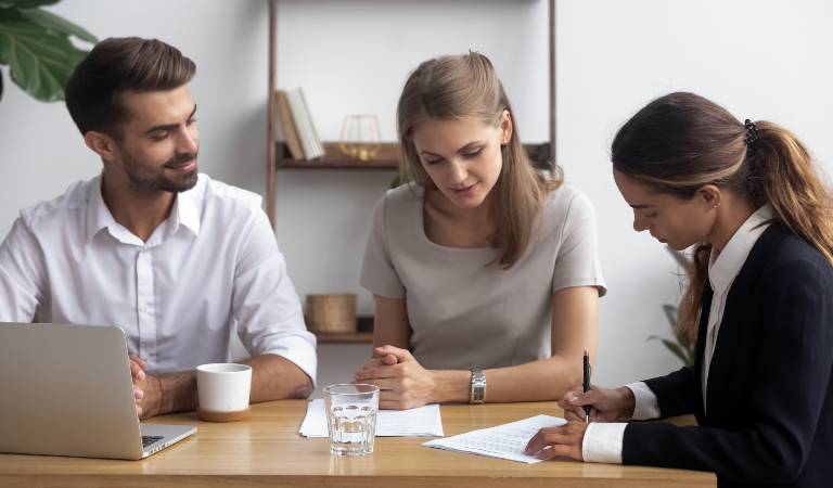man and woman sitting together with a woman lawyer