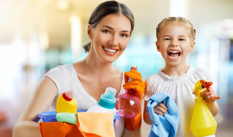 Woman and a kid in white dress holding bottles and tools