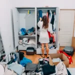 Woman in white dress decluttering her bedroom