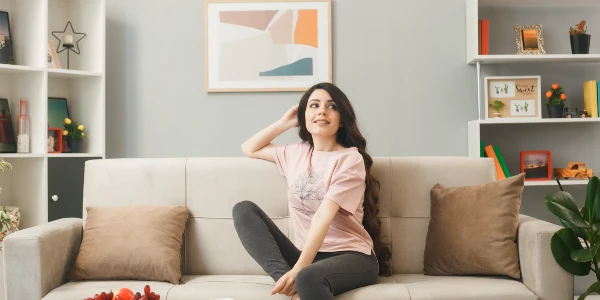 Woman sitting on sofa inside her living room