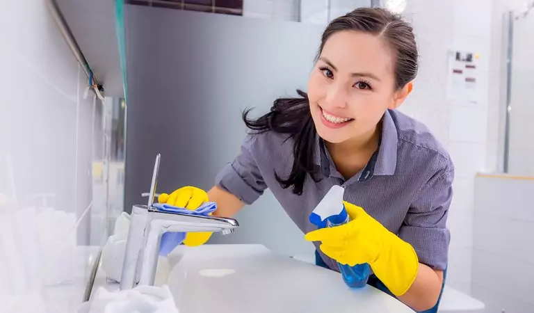 woman cleaning a bathroom