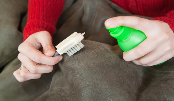 Woman cleaning a sofa