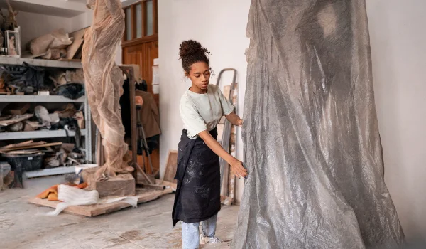 Woman standing in a room filled with waste or materials