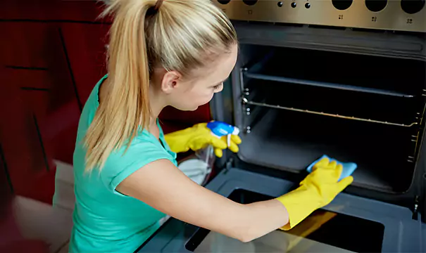 Girl Cleaning Oven