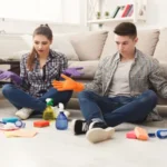 Housewife and her husband cleaning home with cleaning tools
