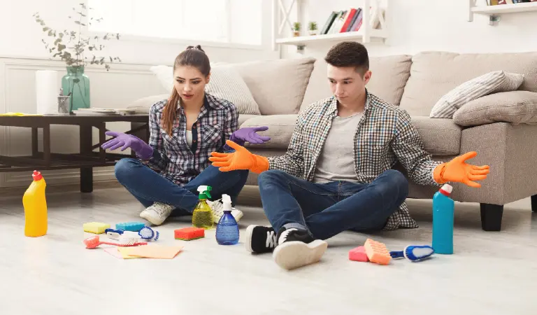 Housewife and her husband cleaning home with cleaning tools