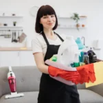 Caucasian woman cleaning worker holding a bucket for washing with detergents