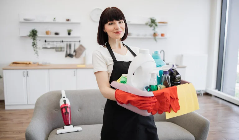 Caucasian woman cleaning worker holding a bucket for washing with detergents