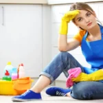 Cleaning concept young woman sitting on the floor with cleaning fluids